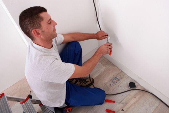 Electrician wiring a home
